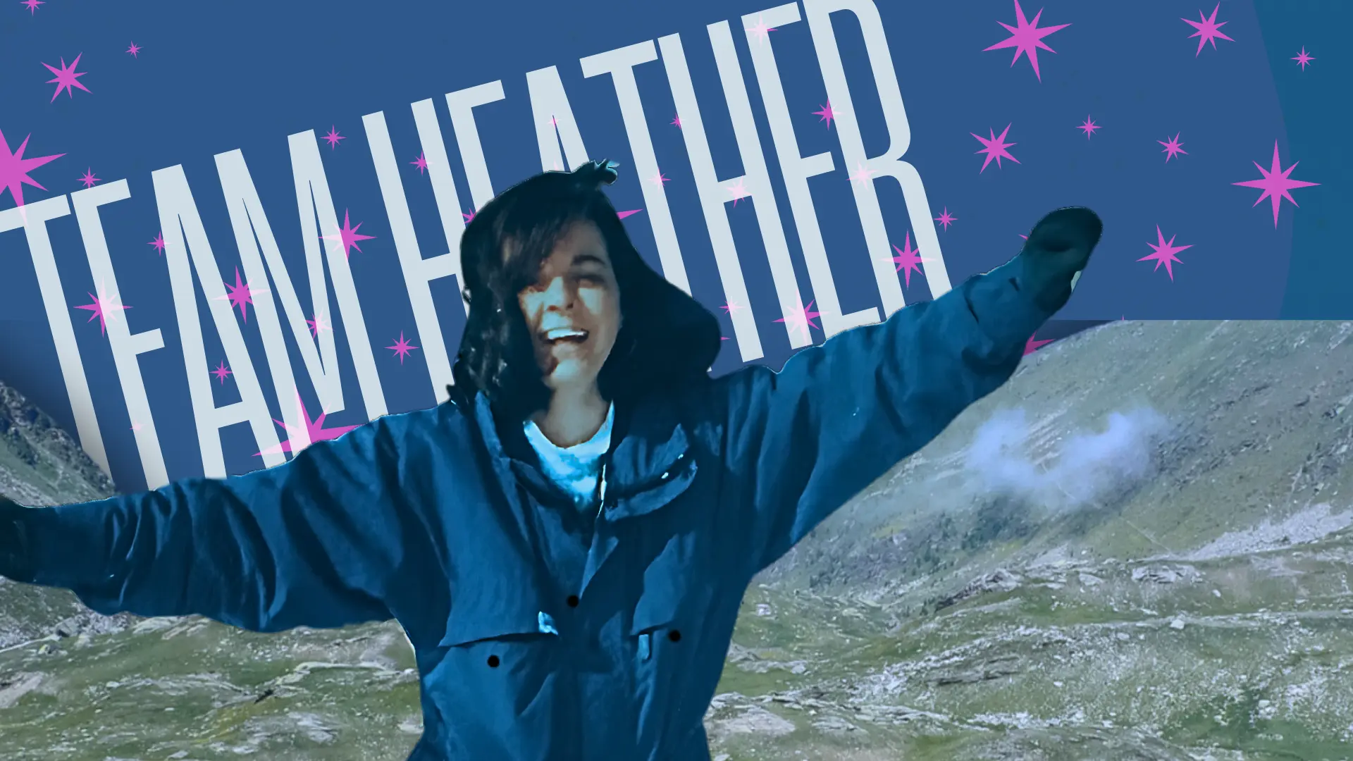 A person in a blue jacket stands with arms outstretched, smiling, in front of a mountainous landscape. The background features text that reads "TEAM HEATHER" with pink stars. The stunning location perfectly captures the essence of Team Heather's adventurous spirit.