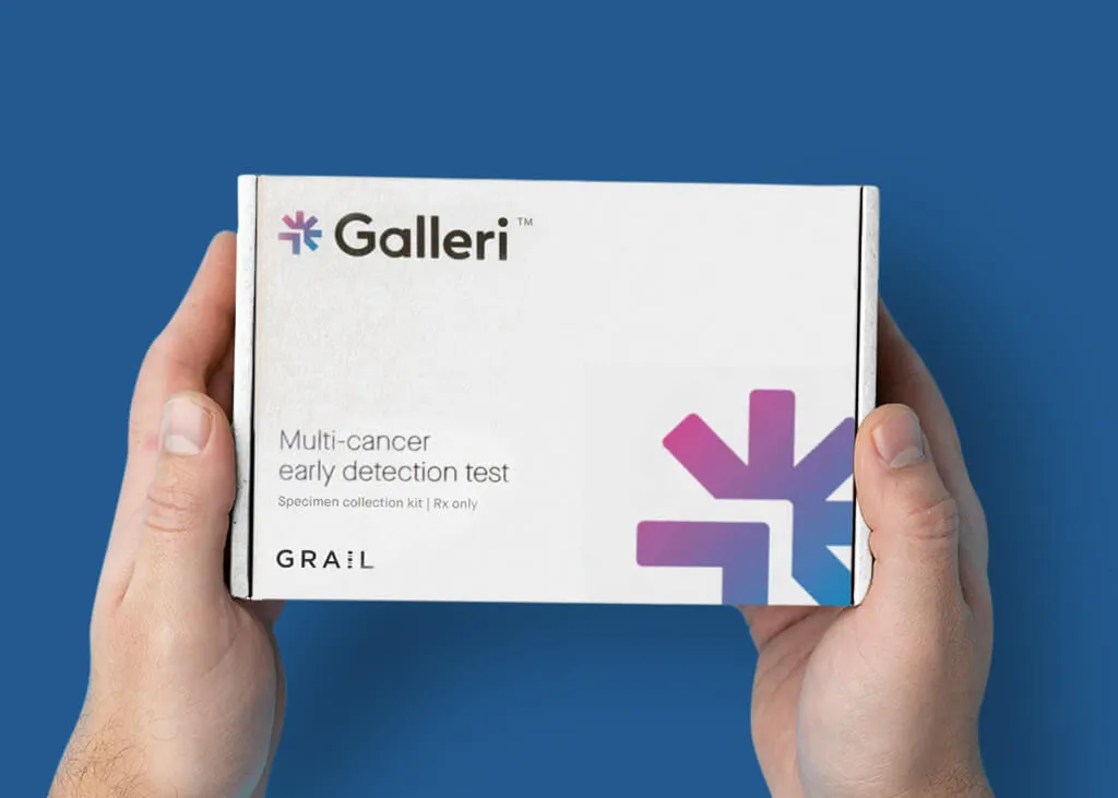 White medical test kit box featuring Galleri logo and multi-cancer early detection test labeling, displayed against deep blue background.
